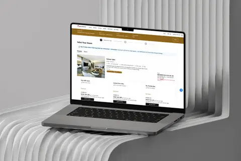 Laptop on a sculpted white stand showing the MHR hotel rate card