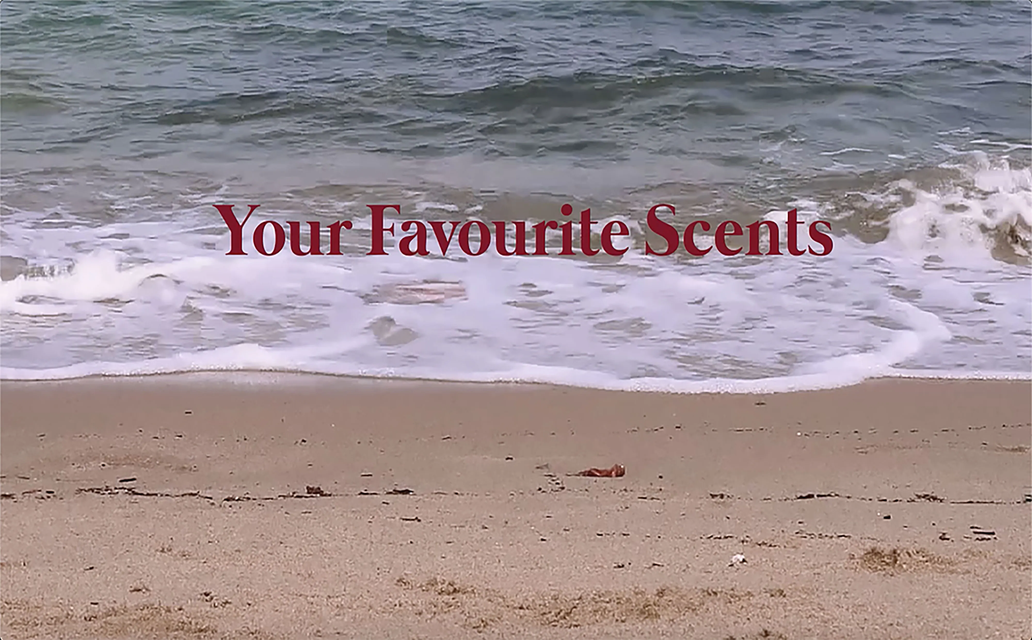 Video still: waves on a beach with the title Your Favourite Scents